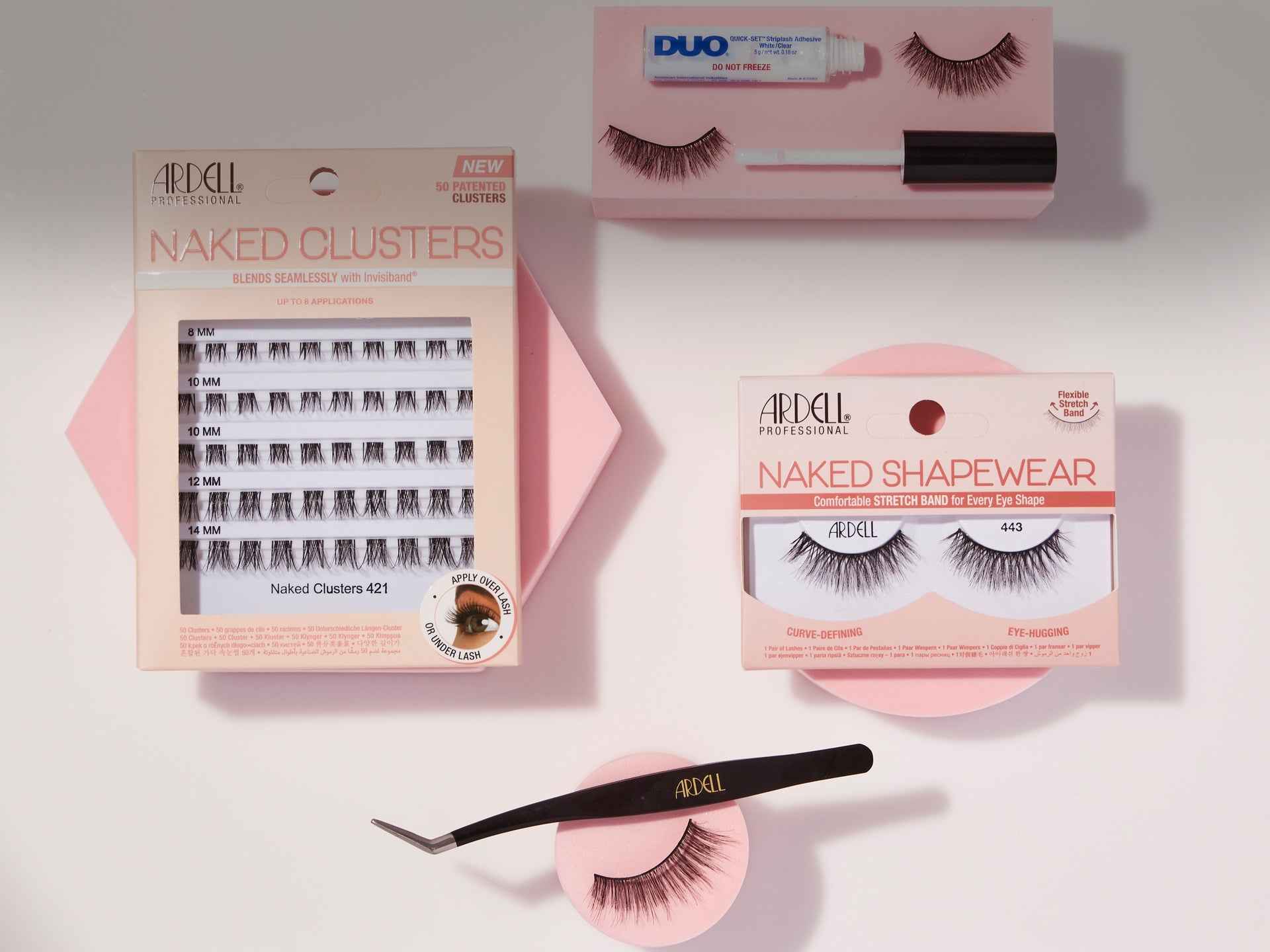 A flat-lay product arrangement of false eyelashes and lash tools on a light gray background. Visible items include a boxed pair of '4EQL Naked Clusters' lashes, a boxed pair of '4EQL Naked Shapewear' lashes, a pair of black tweezers with gold '4EQL' branding, and a pink-and-white tube labeled 'DUO'.